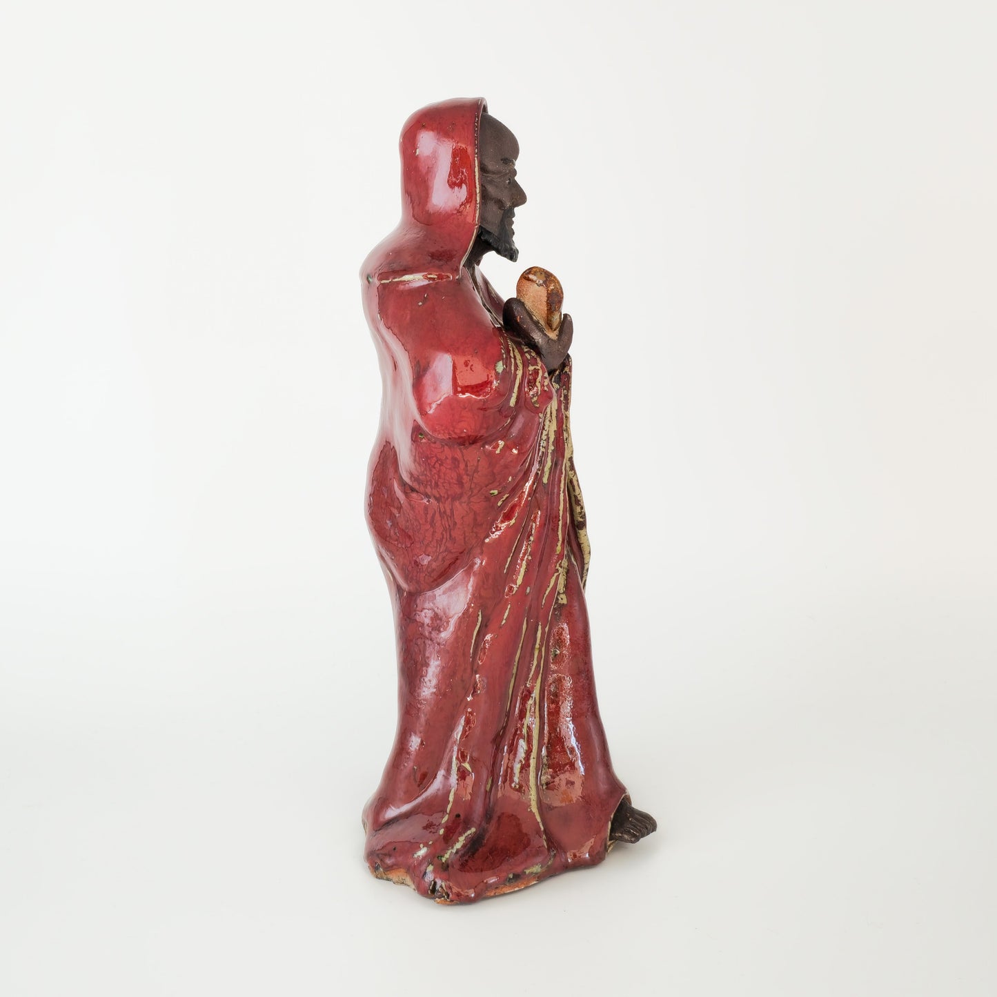 A CHINESE SHIWAN WARE SANG-DE-BOEUF STONEWARE FIGURE OF A LUOHAN | 19TH CENTURY