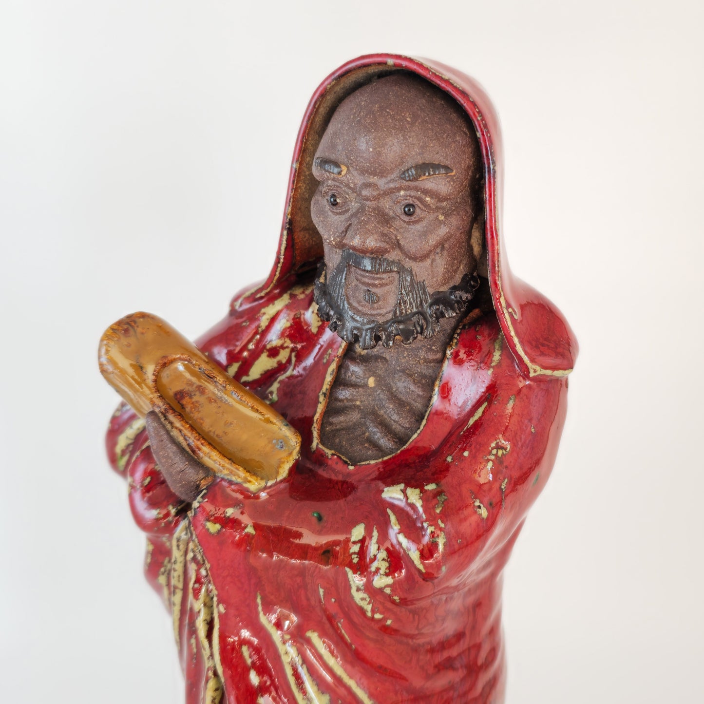 A CHINESE SHIWAN WARE SANG-DE-BOEUF STONEWARE FIGURE OF A LUOHAN | 19TH CENTURY