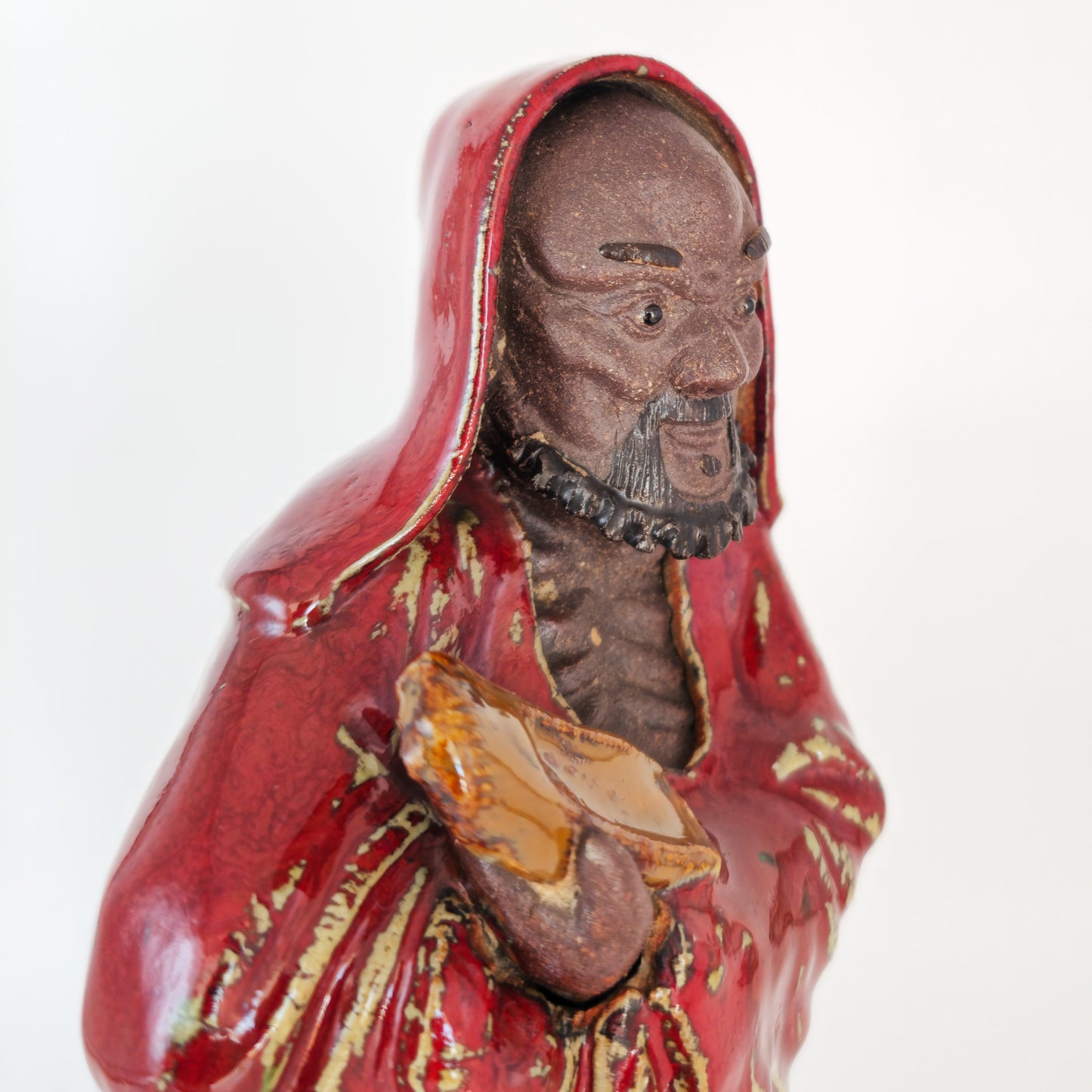 A CHINESE SHIWAN WARE SANG-DE-BOEUF STONEWARE FIGURE OF A LUOHAN | 19TH CENTURY