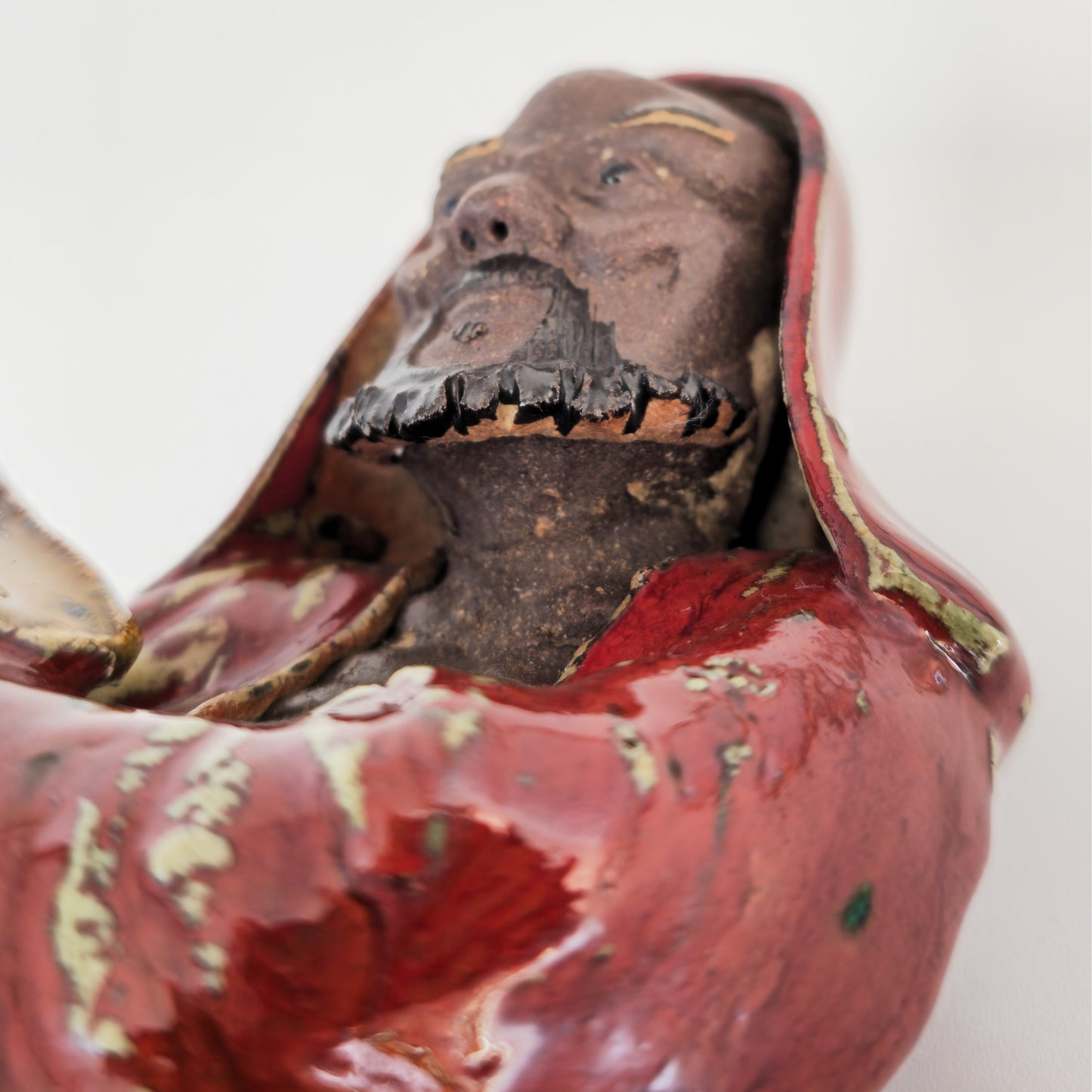 A CHINESE SHIWAN WARE SANG-DE-BOEUF STONEWARE FIGURE OF A LUOHAN | 19TH CENTURY